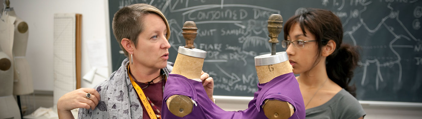 A fashion student works with a faculty member to create a purple outfit